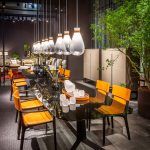 Tan Leather Dining Chair with Dark Wood Frame and Sleek Curved Design