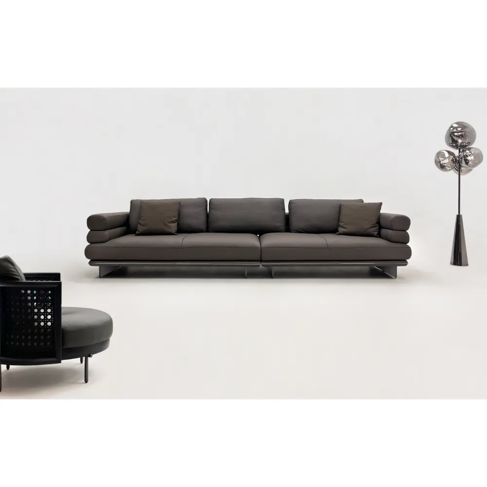 Beige Curved Sofa with Metal Base and Plush Throw Pillows