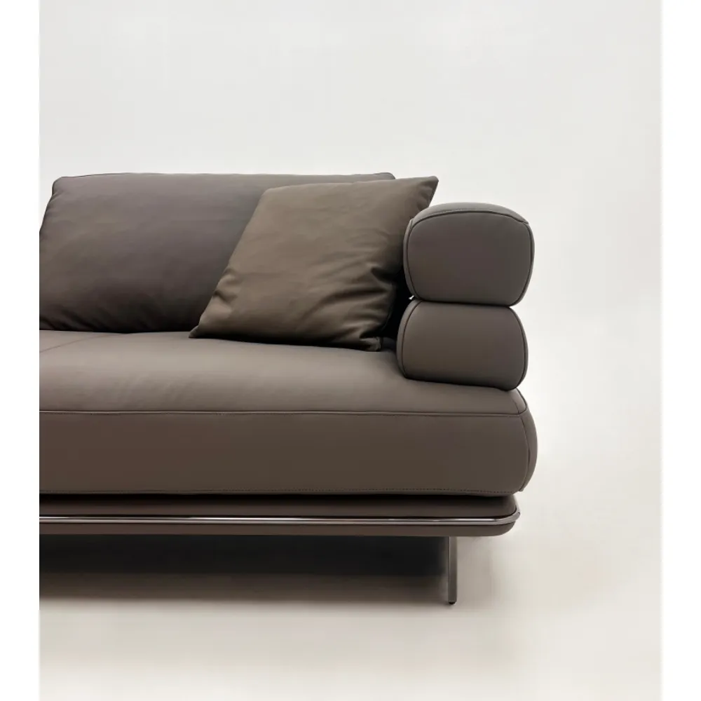 Beige Curved Sofa with Metal Base and Plush Throw Pillows