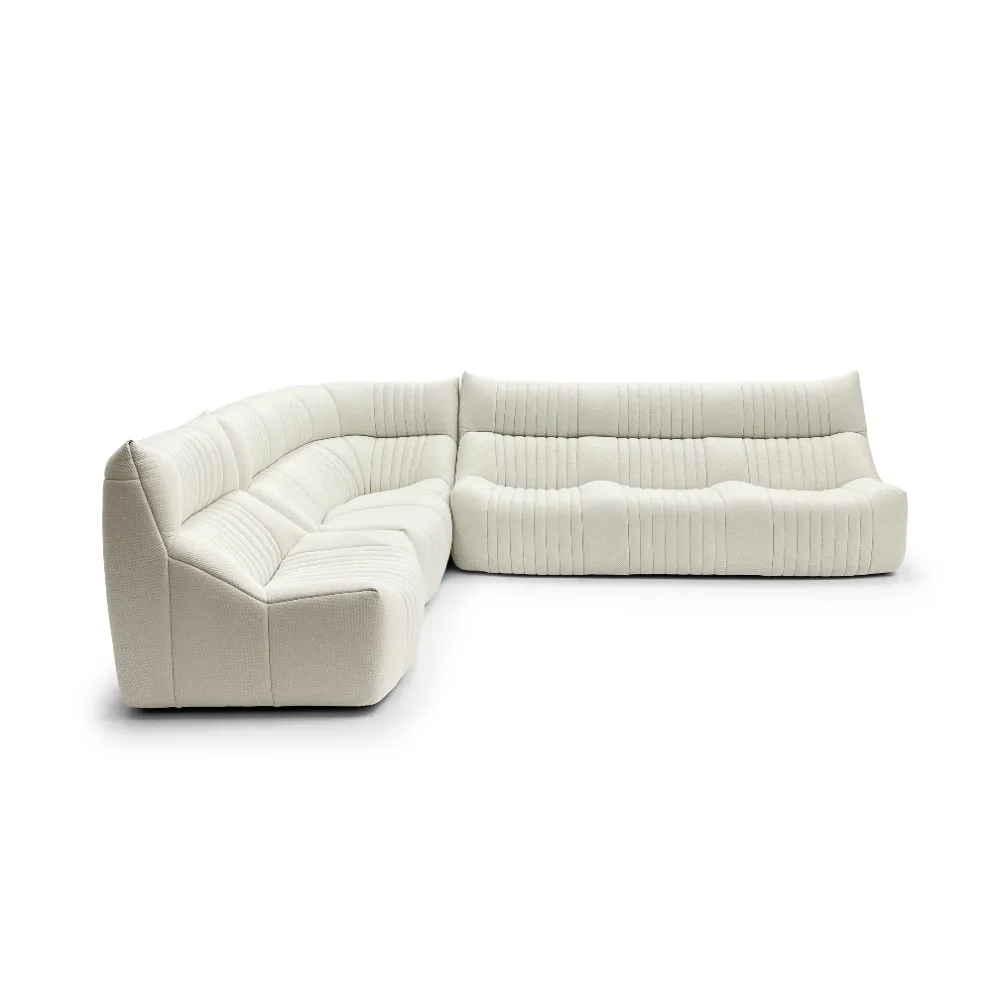 Sleek cream textured fabric L-shaped four-seater sectional sofa. Modern channel tufting and cozy comfort ideal for contemporary living rooms.